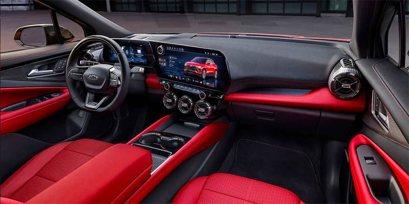The red and black leather interior and front dashboard of an all new 2024 Chevy Blazer EV. - Ted Britt Chevrolet Sterling, VA
